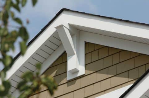 View of the house from the ground that shows the soffit and rainware installed at the roof line.