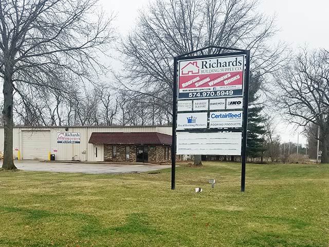 Richards Building Supply in Elkhart, IN. One story beige building with company sign in front