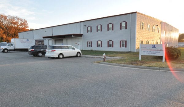 Richards Building Supply in Hampton, VA. Two story beige metal building.