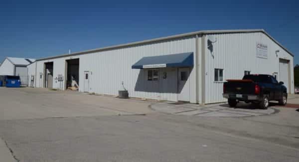 Richards Building Supply in Kaiser, MO. Single story, beige metal building.