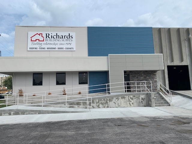 Richards Building Supply in Kansas City, KS. Grey and blue concrete building with wheel chair ramp.