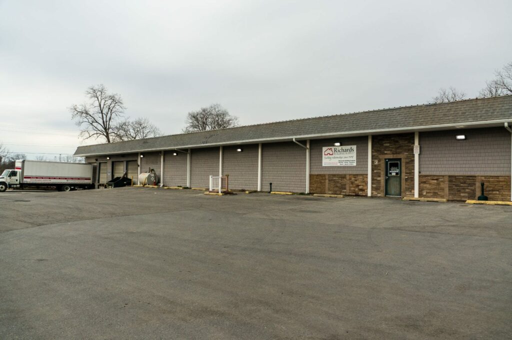 Richards Building Supply in Poughkeepsie, NY. Single story gray building with gray cedar shake siding.