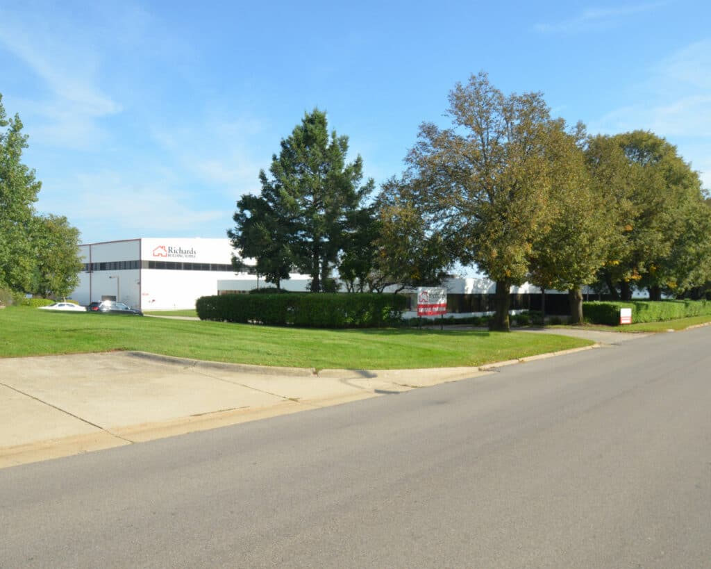 Richards Building Supply in Rockford, IL. Two story, wide white metal building with sign in front.