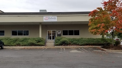 Richard Building Supply in Milford, CT. Wide brown brick building with a large parking lot