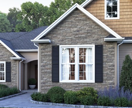 The front of a house using gray decorative stone siding.