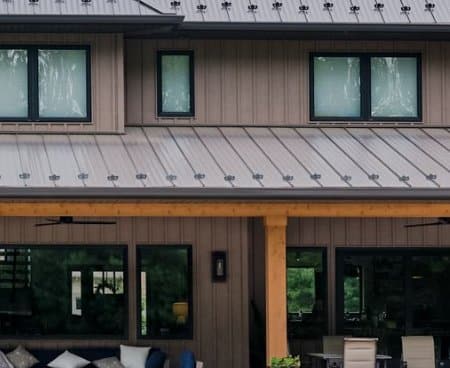 Close up photo the front of a house with brown steel siding.