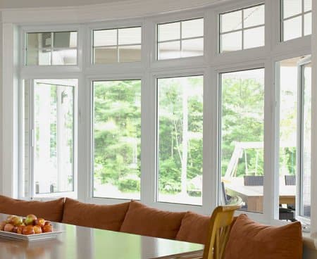 Dinning room photo focusing on the large bow windows. Windows are on a curve.