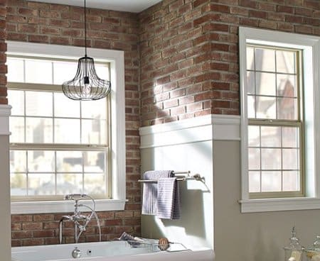 Single hung widows installed in a brick wall above a kitchen sink.