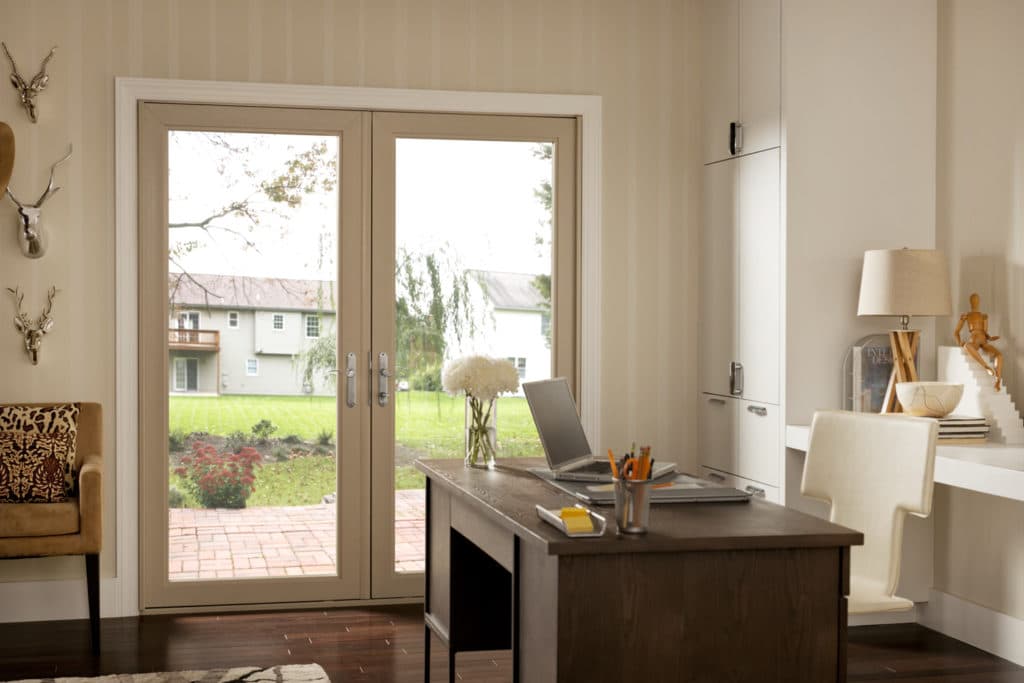 Swinging patios glass entry with a beige frame.