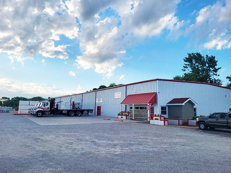 Richards Building Supply in Champaign, IL. One story white metal building with red trim